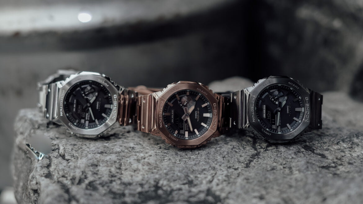 image of three Casio GM-B2100 watches on a rock