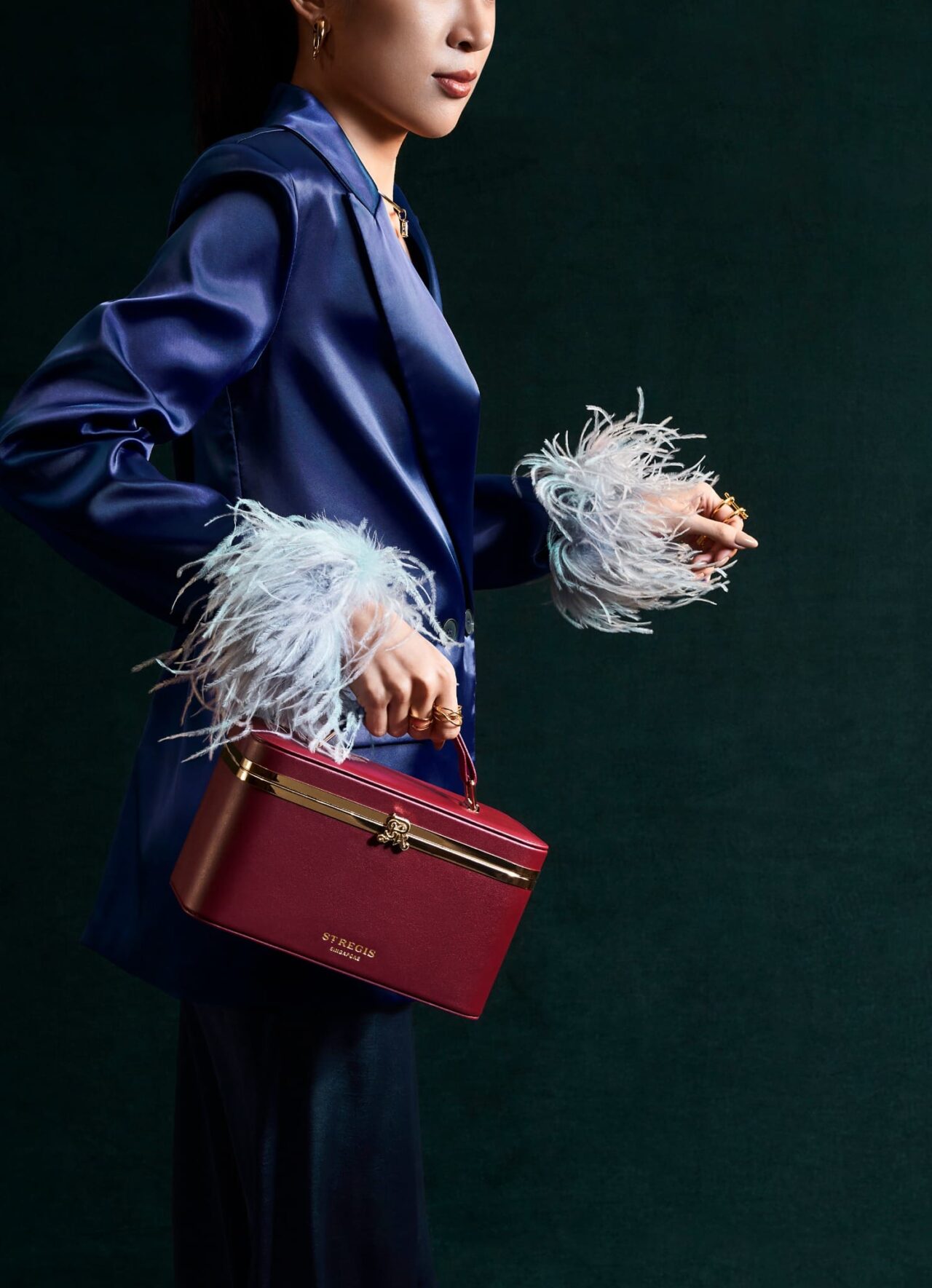 Model carrying The St. Regis Singapore burgundy leather mooncake bag with gold hardware