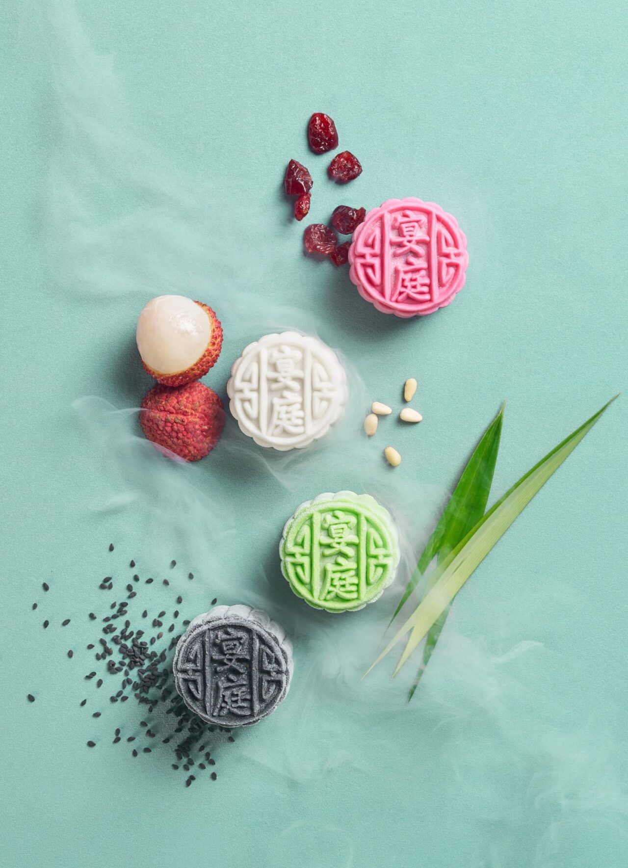 Pink, white, green and charcoal mini snowskin mooncakes with lychee, cranberries, pandan and black sesame