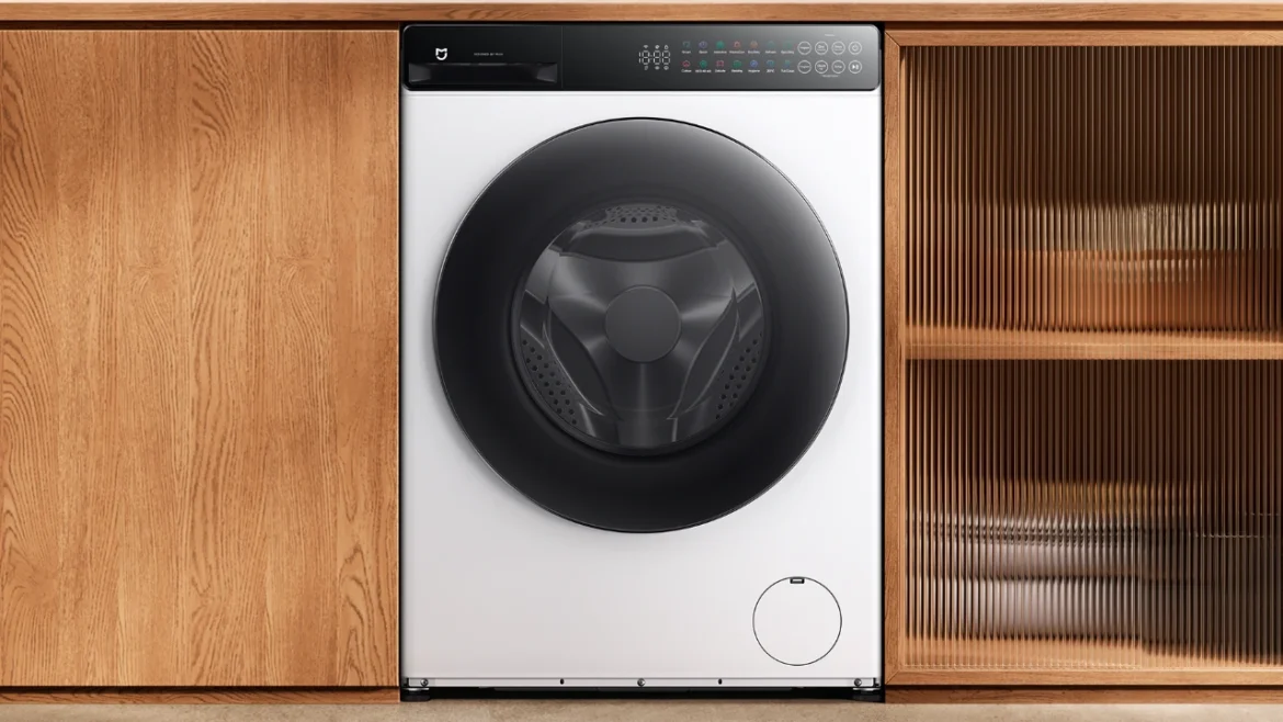 White Mijia Front Load Washer Dryer 9kg installed beneath a wooden counter in a Xiaomi promotional image.
