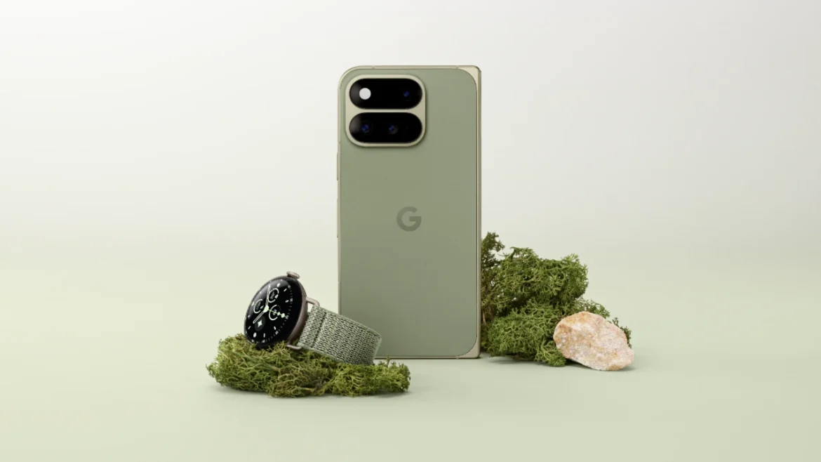 Olive Google Pixel 11 Pro Fold shown closed beside a Pixel Watch on a green display set.