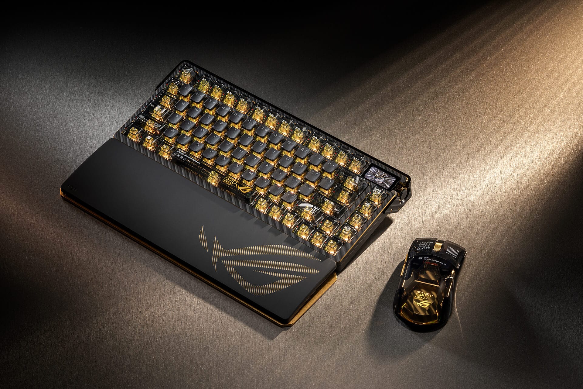 Black-and-gold ROG Azoth Extreme Edition 20 keyboard and Harpe II Extreme Edition 20 mouse photographed together.