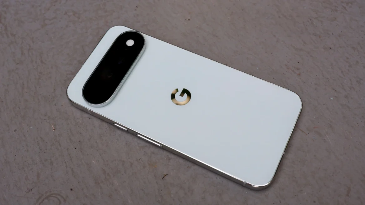 White Google Pixel 11 Pro XL lying face-down on a grey surface, showing the rear camera bar and G logo.