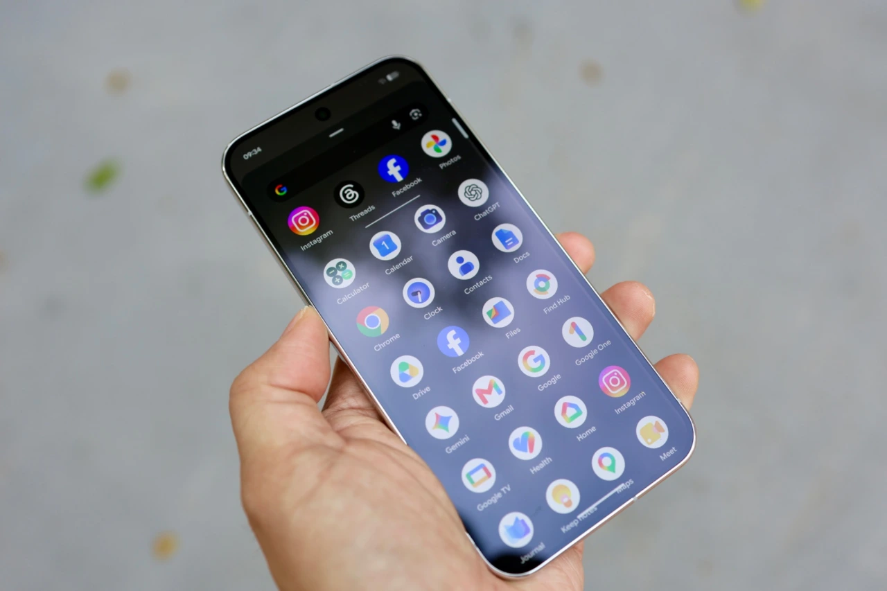 Google Pixel 11 Pro XL held in one hand with the Android app drawer open on screen.